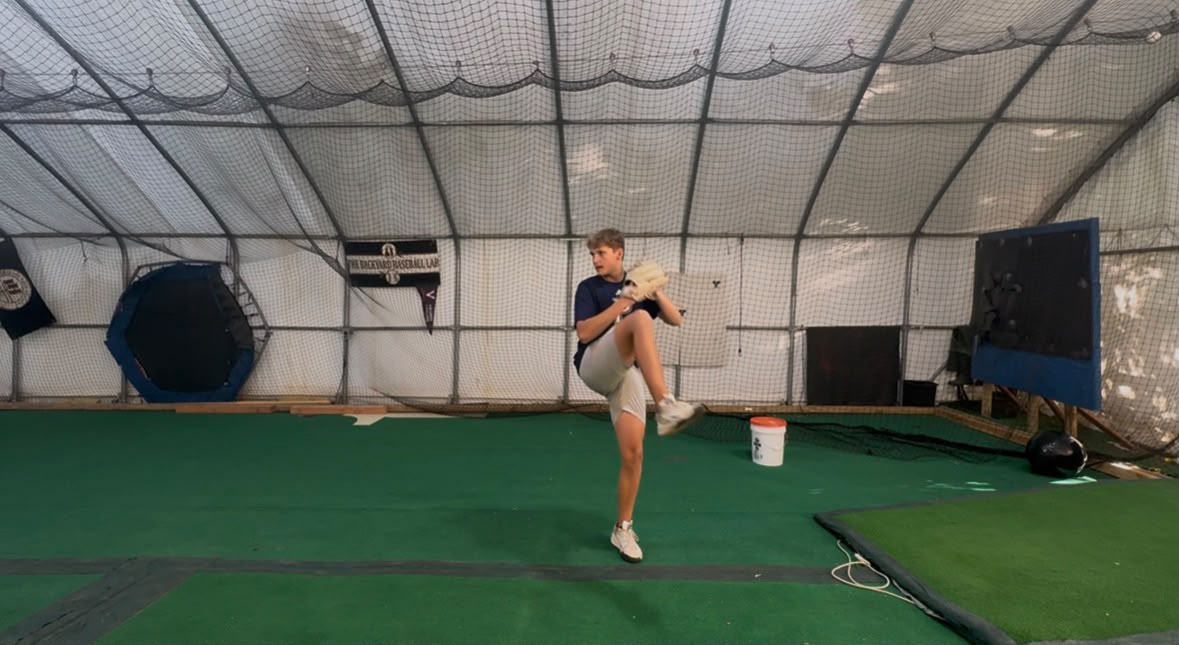 An athlete practicing his pitching delivery inside the Backyard Baseball Lab